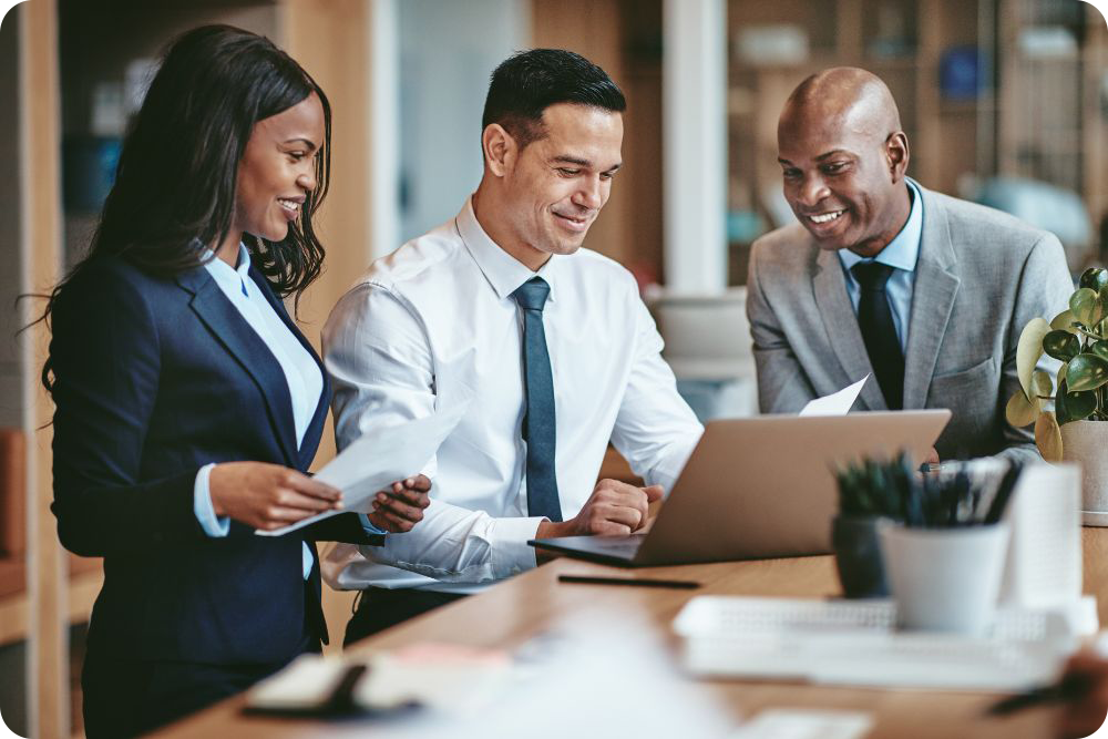 three professional co-workers working on a strategy for a client