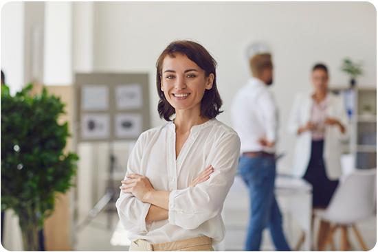 Business woman in the office smiling at camera